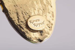 Keren Kopal Frog Holding a Surfboard