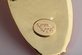 Keren Kopal Frog Holding a Surfboard