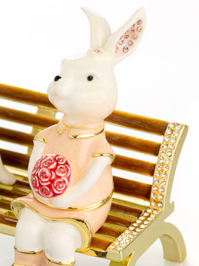 2 bunnies in love sitting on a bench, valentine flowers and chocolates